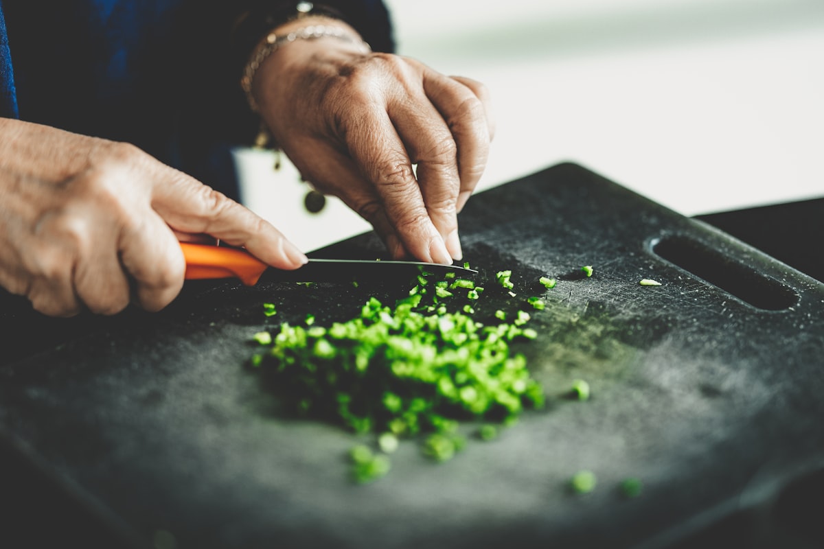 Person preparing fresh vegetables in a kitchen